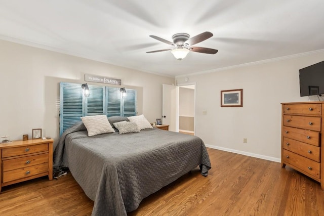 bedroom featuring hardwood / wood-style flooring, ceiling fan, and ornamental molding