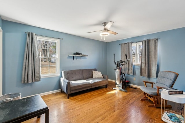 sitting room with hardwood / wood-style flooring and ceiling fan