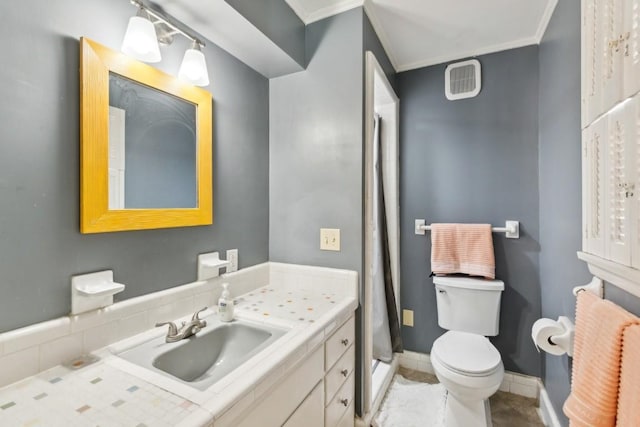 bathroom featuring vanity, tile patterned floors, ornamental molding, and toilet