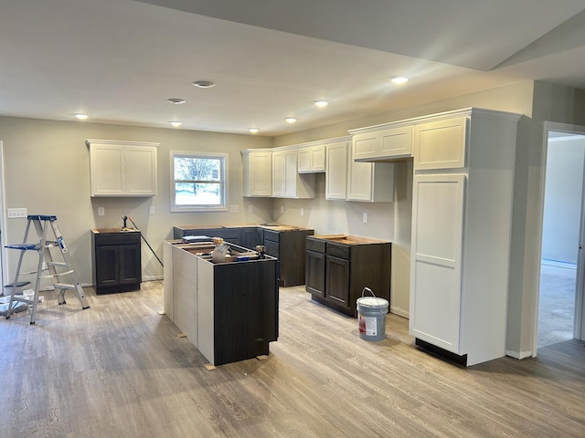 kitchen featuring light hardwood / wood-style floors, white cabinets, and a kitchen island