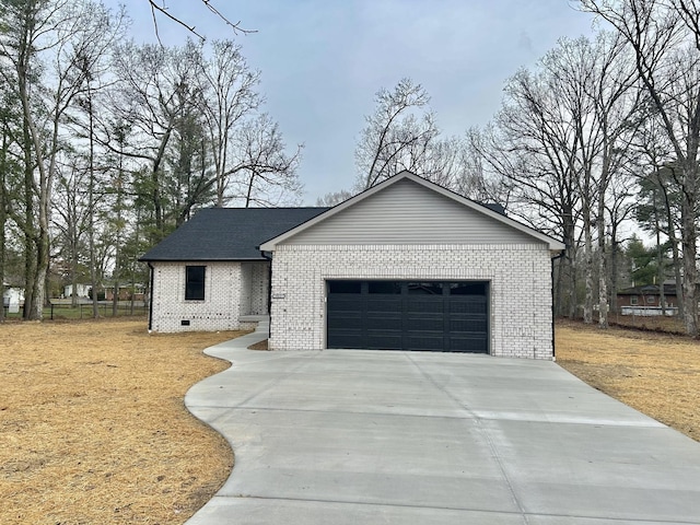 view of front of home featuring concrete driveway, an attached garage, and brick siding