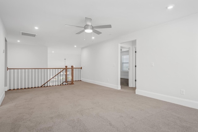 spare room with light carpet and ceiling fan