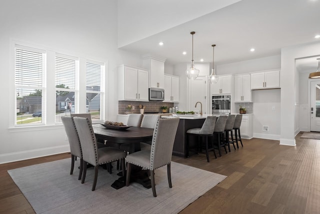 dining area featuring dark hardwood / wood-style flooring and sink