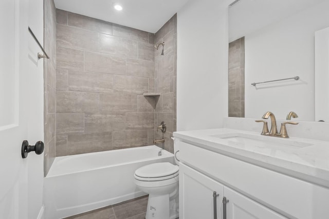 full bathroom with vanity, toilet, and tiled shower / bath combo