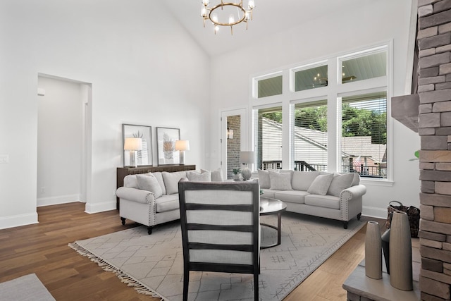 living room featuring hardwood / wood-style floors, a towering ceiling, and a wealth of natural light