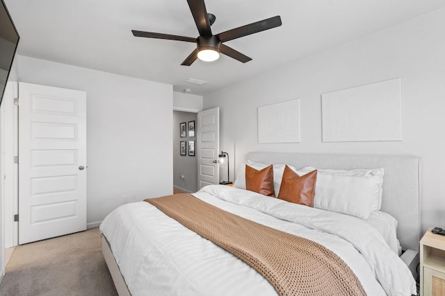 bedroom featuring light colored carpet and ceiling fan