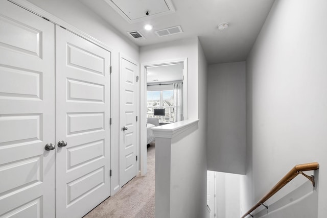 hallway with light colored carpet