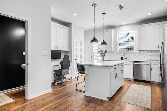 kitchen featuring dark wood-type flooring, dishwasher, white cabinetry, hanging light fixtures, and a kitchen island