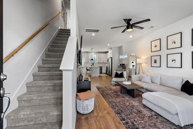 living room with ceiling fan and wood-type flooring