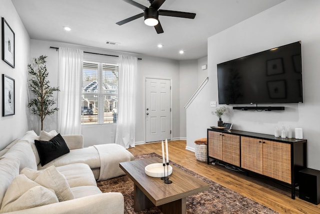 living room featuring hardwood / wood-style flooring and ceiling fan