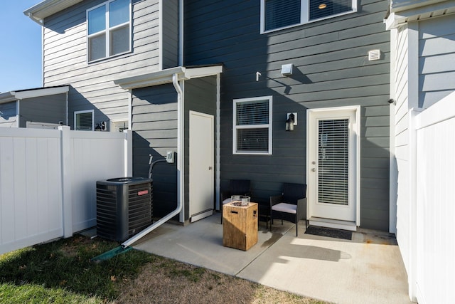 rear view of property with central AC unit and a patio area