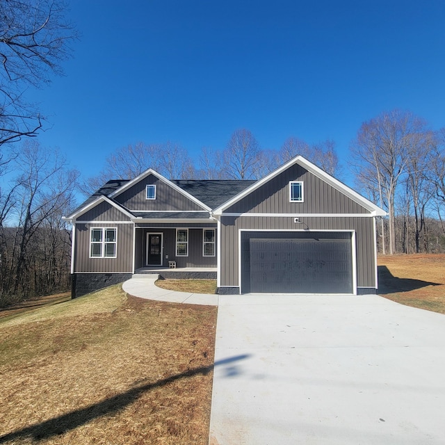 view of front of house with a garage and a front lawn