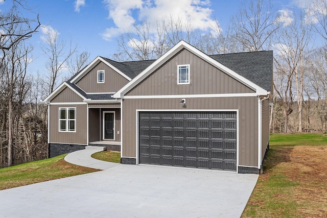 view of front of home with a garage and a front lawn