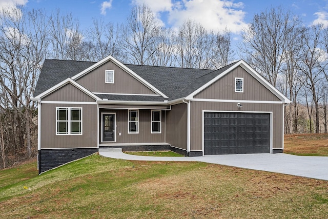 view of front of house featuring a front lawn and a garage