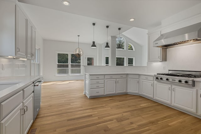 kitchen featuring stainless steel appliances, white cabinetry, kitchen peninsula, and decorative backsplash