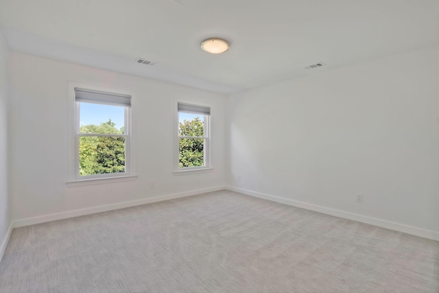 unfurnished room with light colored carpet