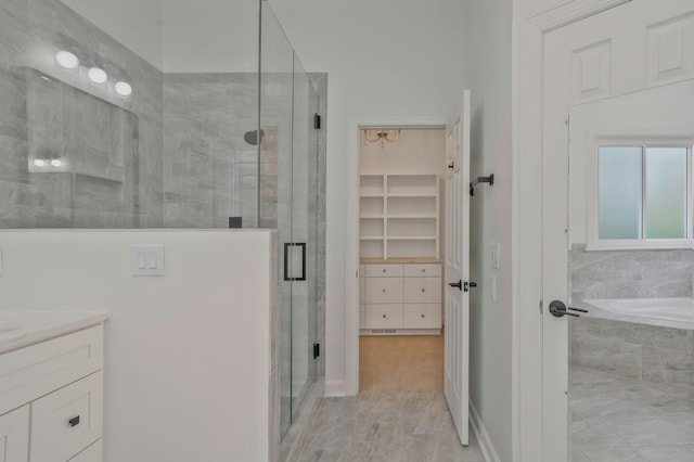 bathroom with vanity and separate shower and tub