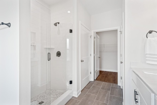 bathroom featuring vanity and an enclosed shower