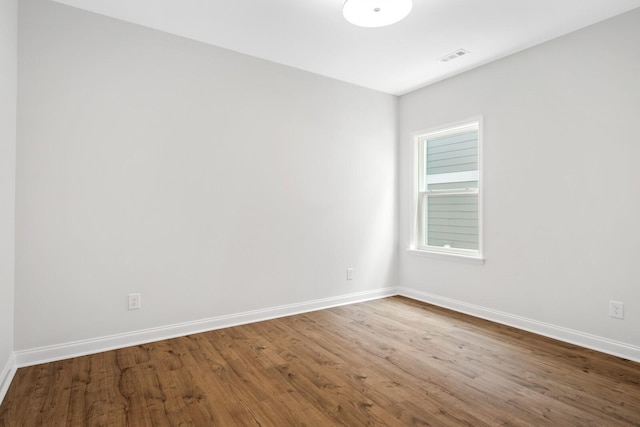 spare room with hardwood / wood-style flooring