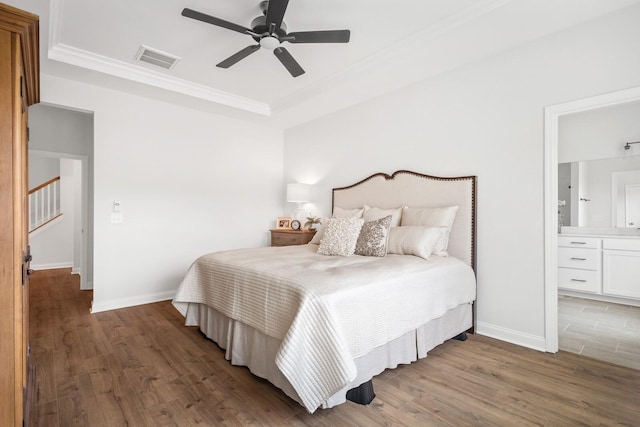 bedroom with crown molding, ensuite bath, ceiling fan, and hardwood / wood-style flooring