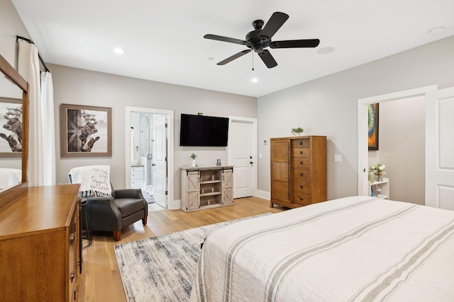 bedroom with ceiling fan, ensuite bathroom, and light hardwood / wood-style flooring