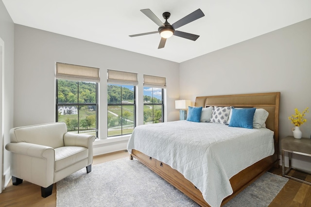 bedroom with wood-type flooring and ceiling fan