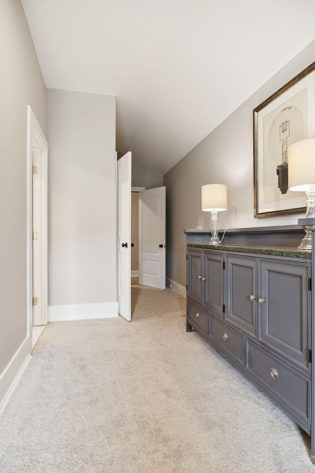 carpeted bedroom with lofted ceiling