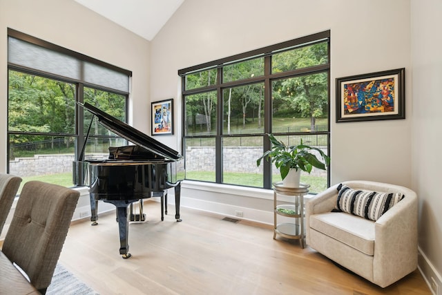 sitting room with lofted ceiling and light hardwood / wood-style floors