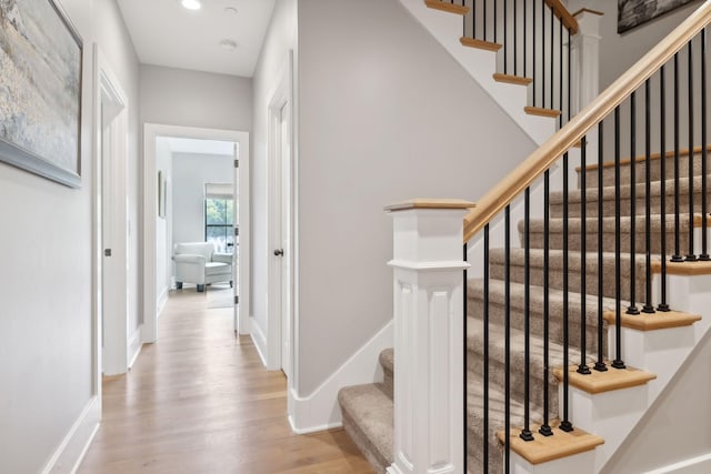 stairway with hardwood / wood-style flooring