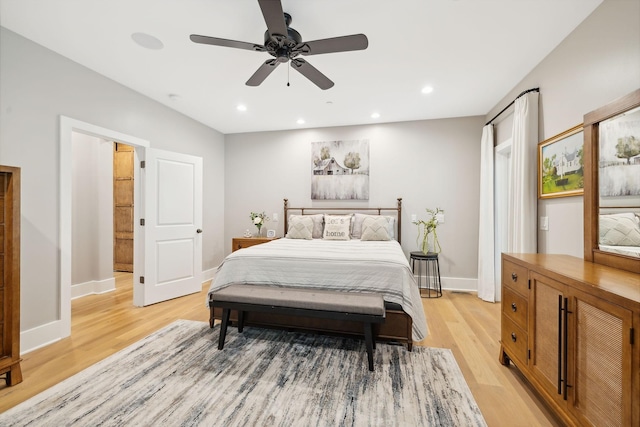 bedroom with ceiling fan and light hardwood / wood-style floors