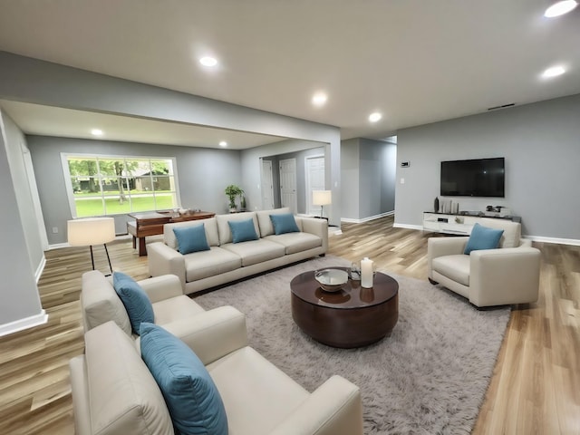 living room with light hardwood / wood-style flooring