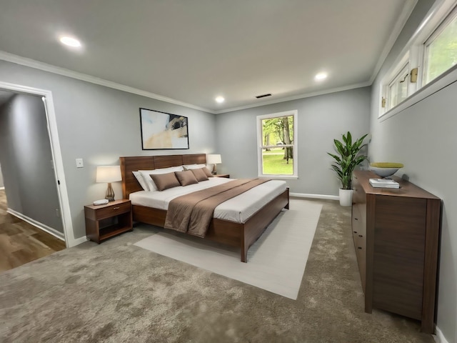 bedroom featuring crown molding and dark colored carpet