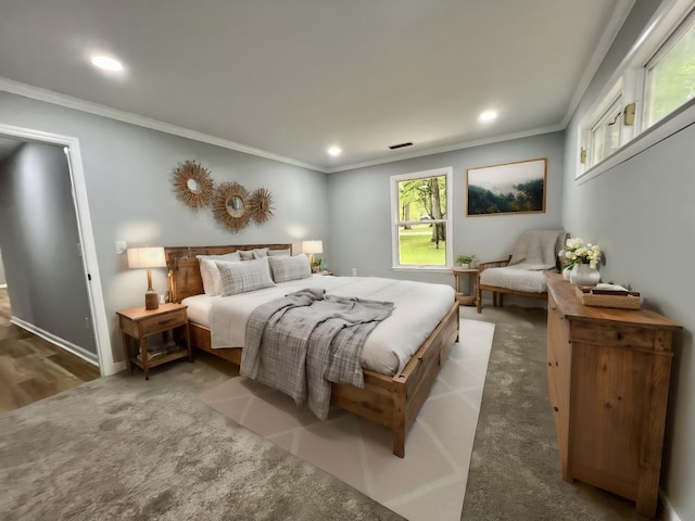 bedroom with crown molding and carpet floors