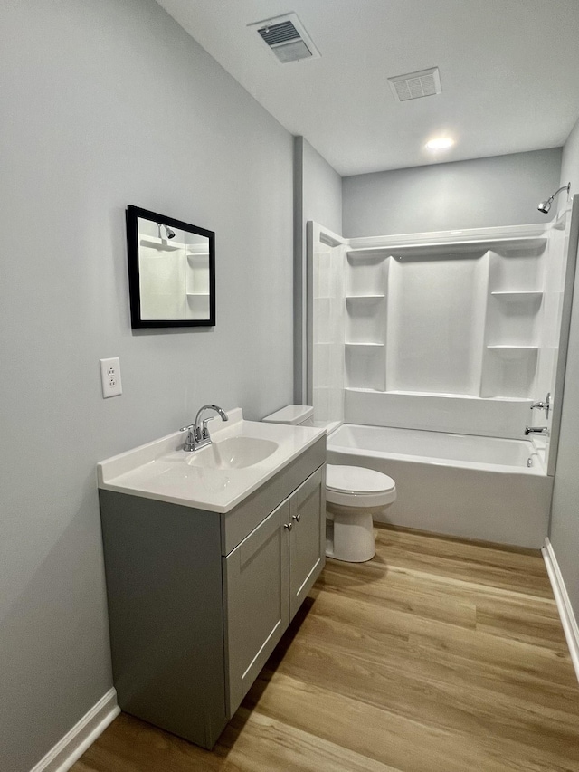 full bathroom featuring vanity, shower / washtub combination, hardwood / wood-style floors, and toilet