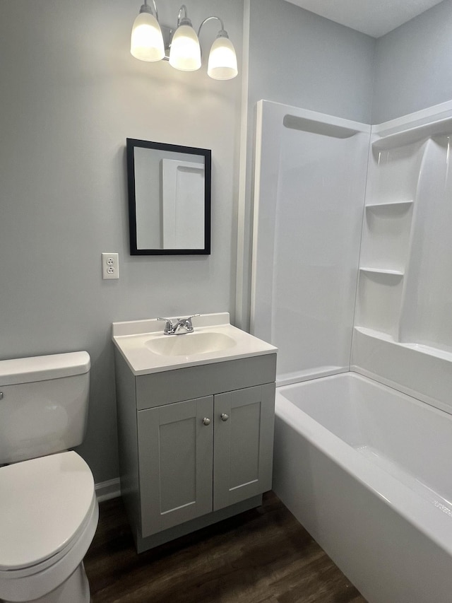 full bathroom featuring wood-type flooring, bathtub / shower combination, vanity, and toilet