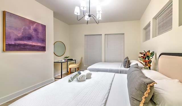 bedroom featuring hardwood / wood-style flooring and an inviting chandelier