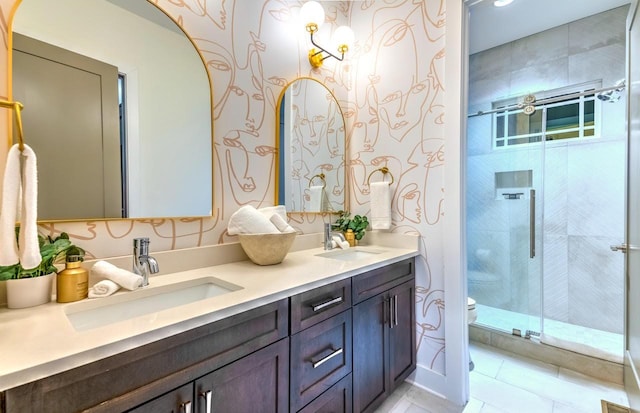 bathroom featuring vanity, a shower with shower door, and toilet