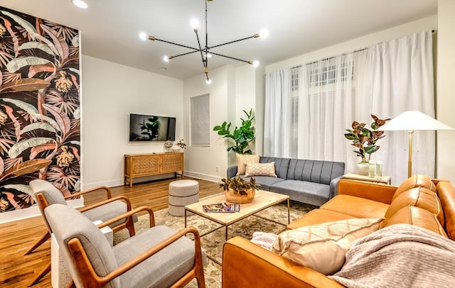 living room with hardwood / wood-style flooring and an inviting chandelier