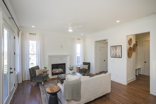 living room with ceiling fan, ornamental molding, and dark hardwood / wood-style floors