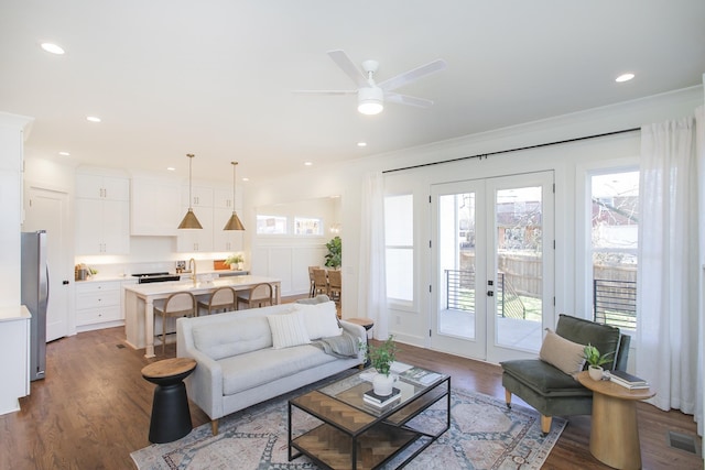 living room featuring ornamental molding, dark hardwood / wood-style floors, ceiling fan, and french doors