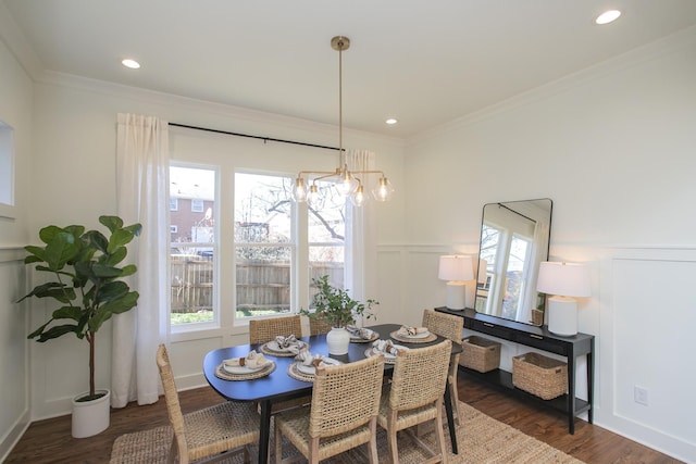 dining room featuring crown molding, plenty of natural light, and dark hardwood / wood-style floors