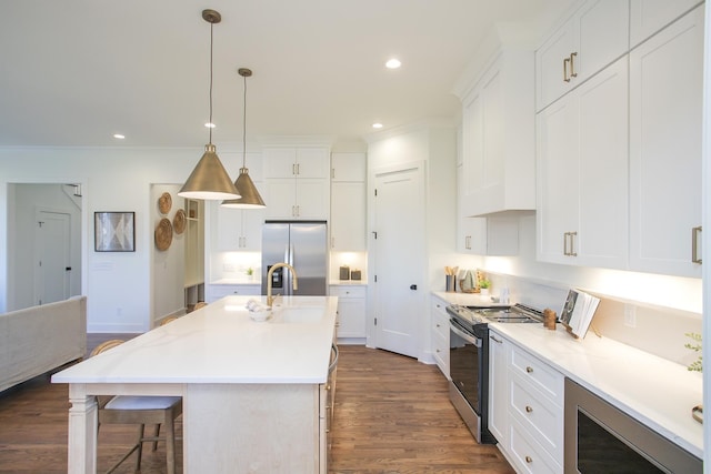 kitchen featuring stainless steel appliances, a kitchen island with sink, and white cabinets