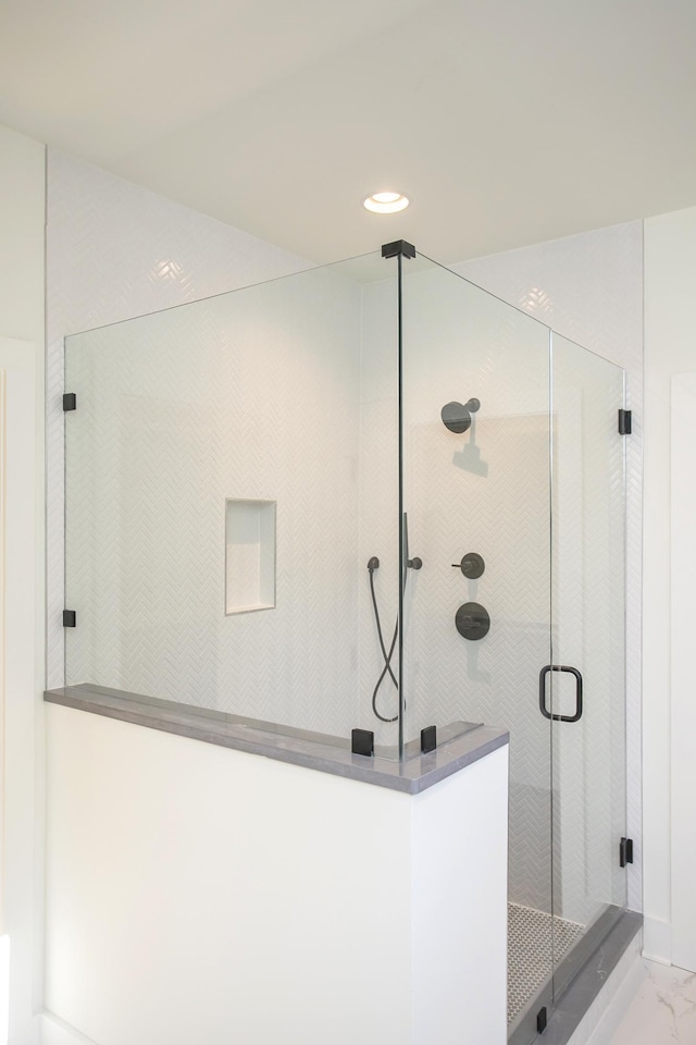 bathroom with a shower with shower door