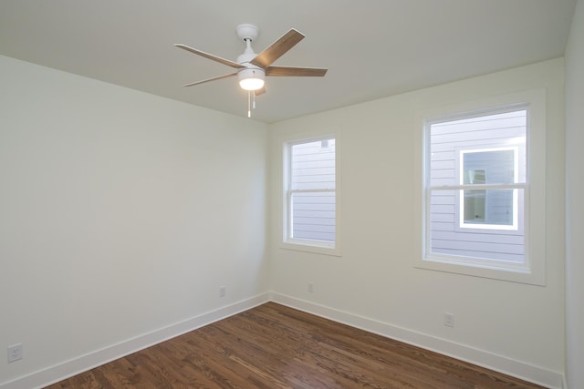 empty room featuring dark hardwood / wood-style flooring and ceiling fan