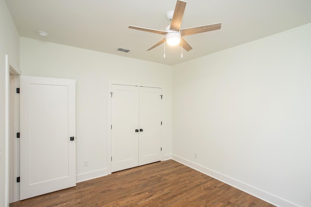 unfurnished bedroom with dark hardwood / wood-style floors and ceiling fan