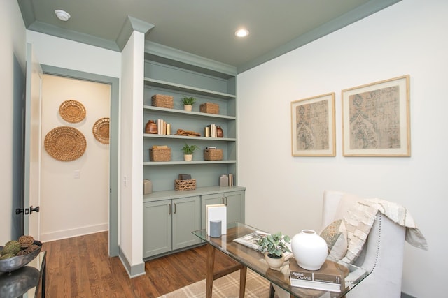 office featuring crown molding, built in shelves, and dark wood-type flooring