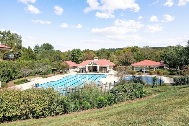 view of swimming pool featuring a patio and a lawn