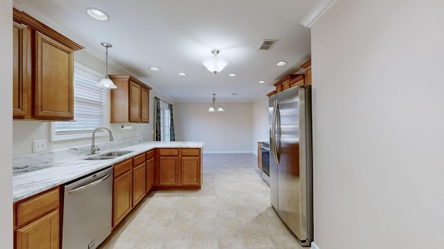 kitchen featuring sink, hanging light fixtures, ornamental molding, kitchen peninsula, and stainless steel appliances