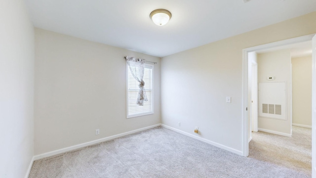 spare room with light colored carpet