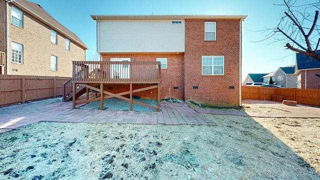 rear view of house featuring a deck and a patio area